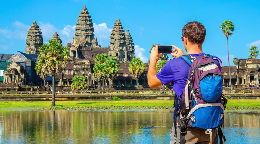 Projects Abroad volunteer explores Cambodia during his free time. Traveller takes a photo of Angkor Wat during his travels through Cambodia.